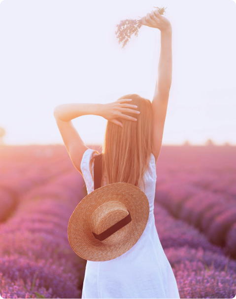 Woman resting in lavender field representing recovery from burnout and emotional exhaustion through therapy