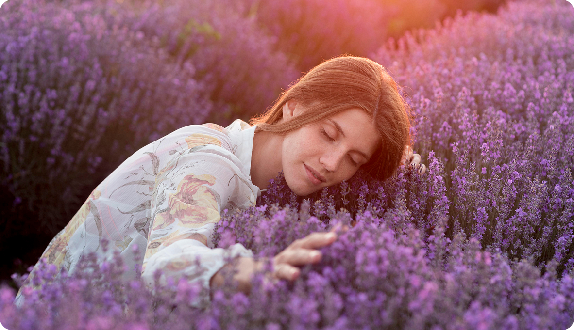 Woman relaxing in lavender field representing relief from anxiety and chronic worry through therapy